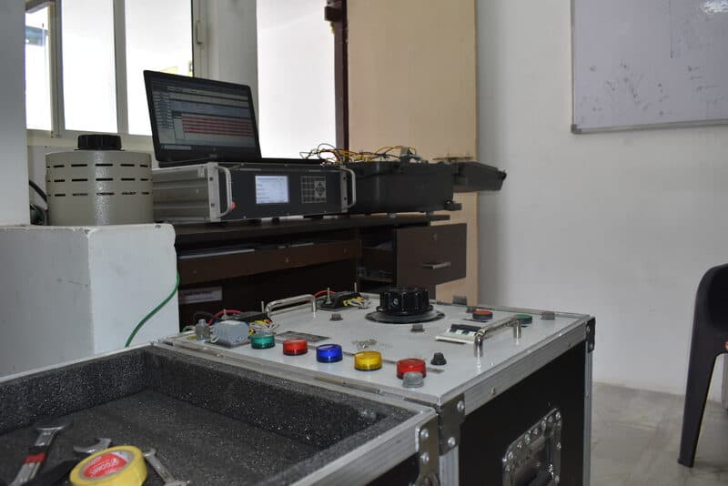 SDES technician calibrating an instrument transformer using an AITTS test set in the NABL lab