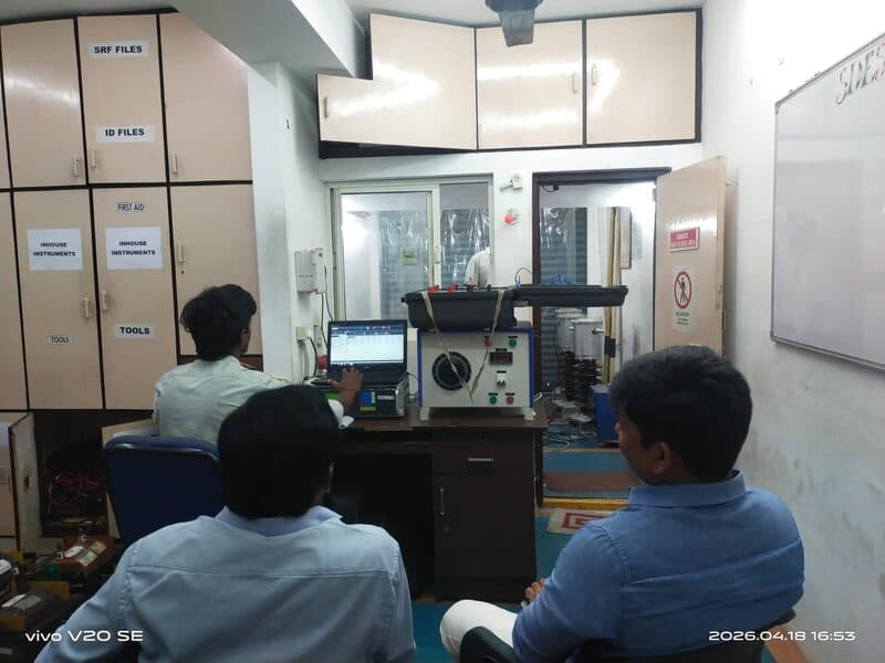 SDES calibration engineers reviewing test results on an instrument transformer test set inside the lab