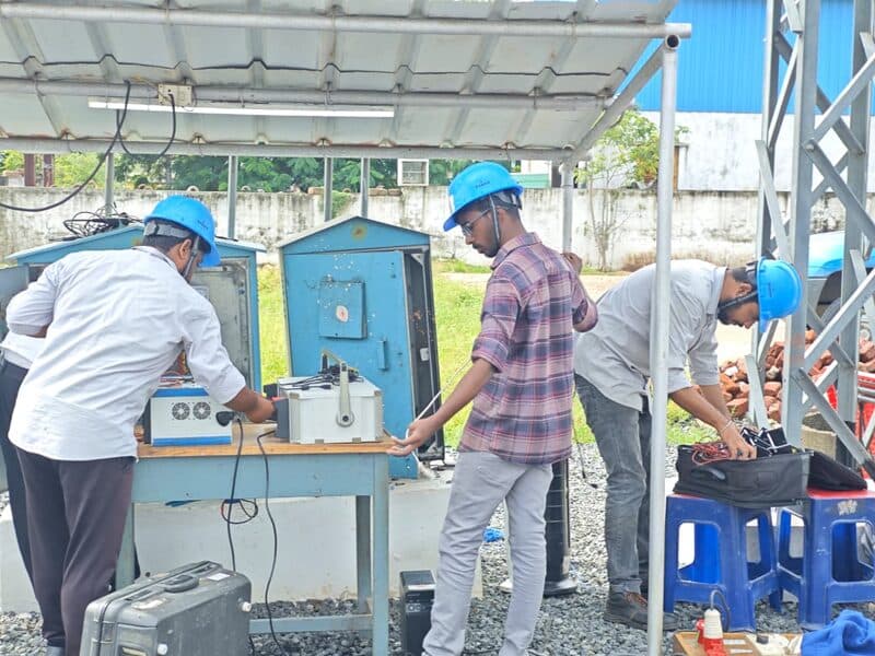 SDES field team in safety helmets calibrating meter panels on-site